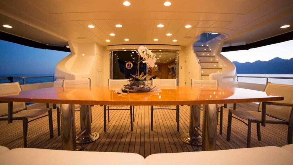 Aft deck dining table on the luxury motor yacht Panfeliss