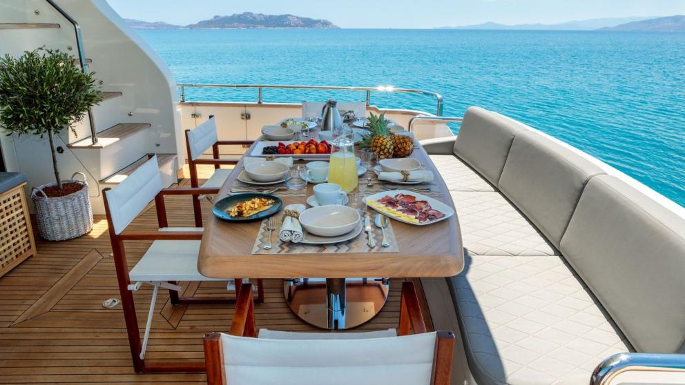 Deck dining table on the luxury motor yacht Freedom