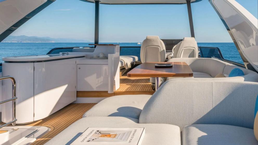 Luxury motor yacht Donna's flybridge with dining table and seating area