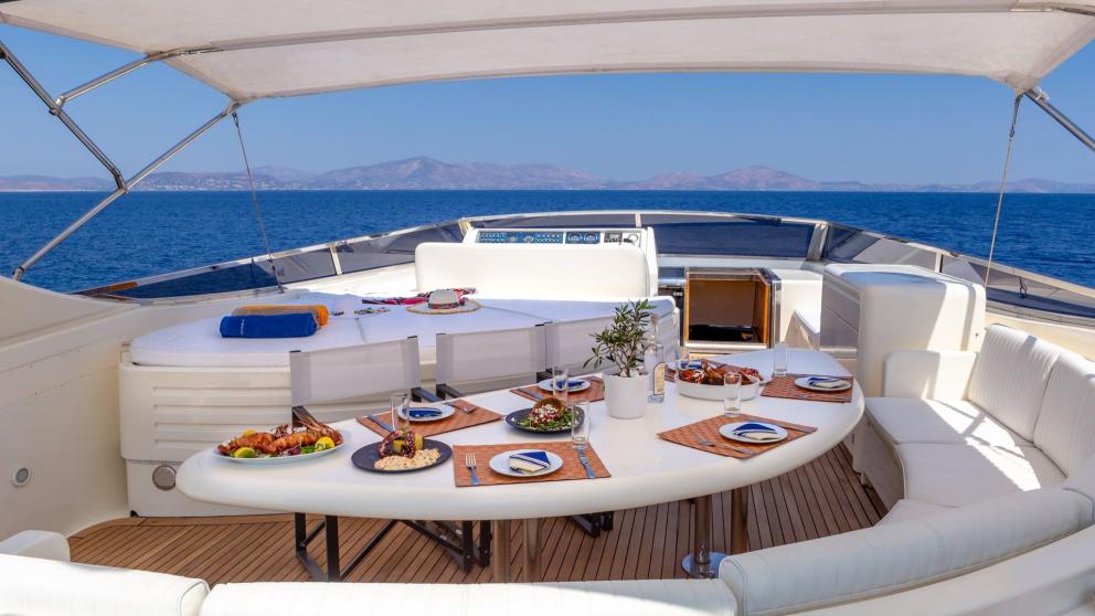 Dining and seating area on the flybridge of luxury motor yacht Efmaria