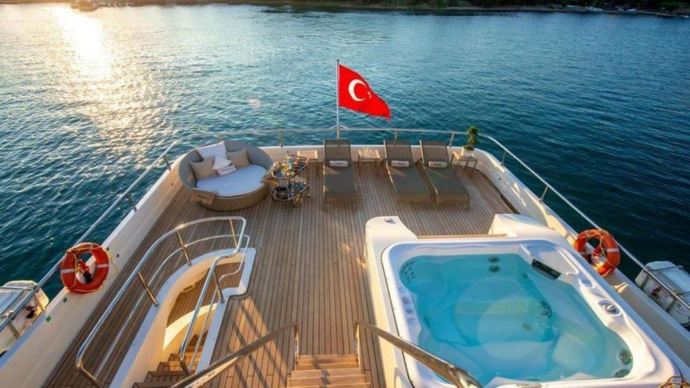Upper deck sunbathing area and Jacuzzi on the luxury motor yacht Panfeliss.